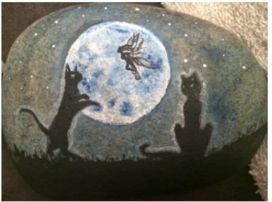 Finished full moon garden stone with two black cat silhouettes and a fairy under a glowing moon